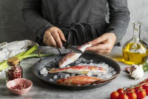 woman-preparing-fish-cooking